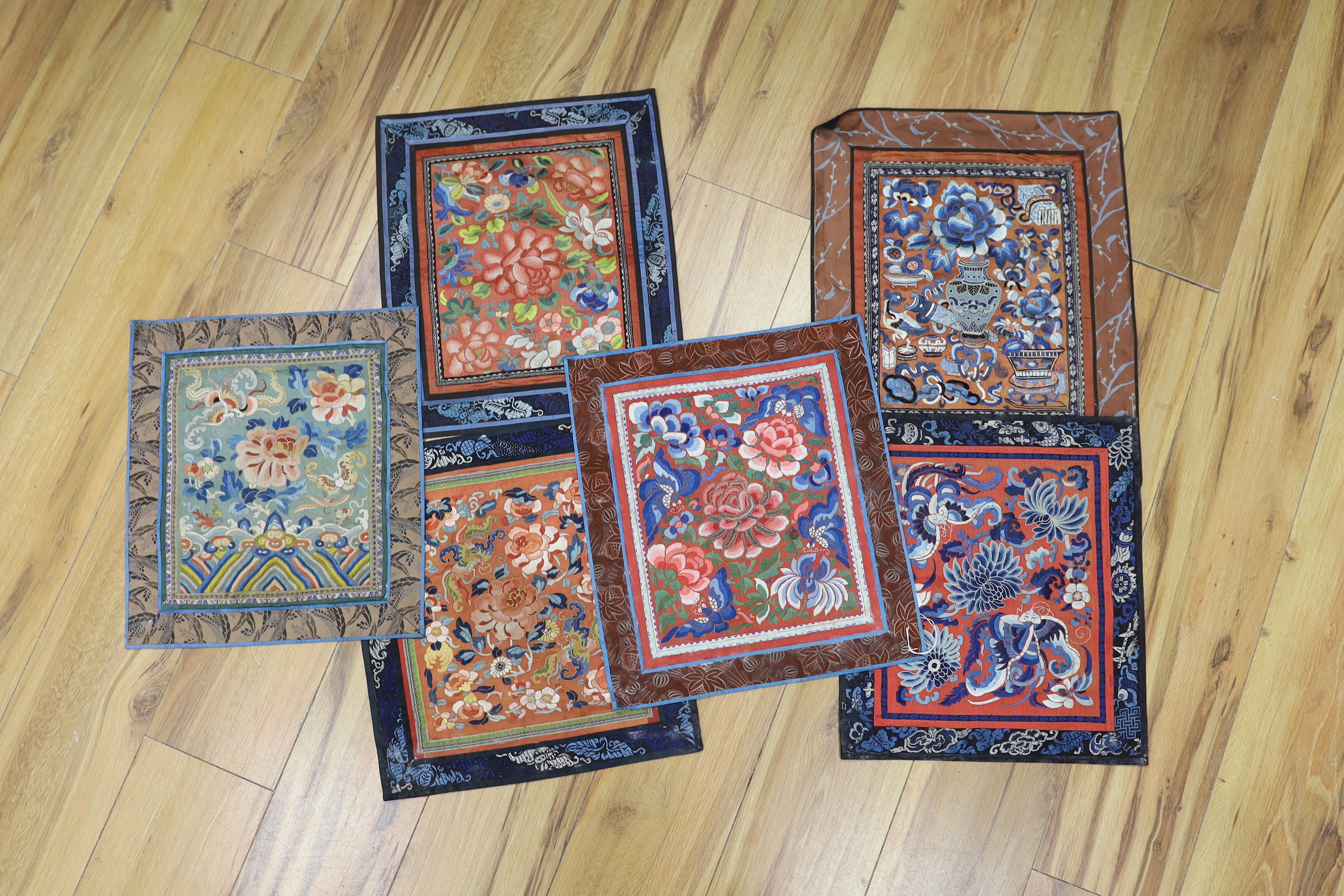 Six panels of Chinese silk embroidered mats, all using mixed stitches including Beijing knot, all bordered with silk brocade